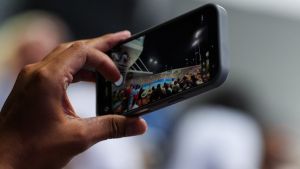 Aug 17, 2026; Mason, OH, USA; A fan uses a phone to watch the doubles match between Serena Williams and Venus Williams of the United States against Marta Kostyuk of Ukraine and Peyton Stearns of the United States during the Cincinnati Open at Lindner Family Tennis Center. Mandatory Credit: Aaron Doster-Imagn Images