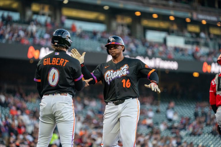 Aug 25, 2026; San Francisco, California, USA; San Francisco Giants first baseman Rafael Devers (16) and San Francisco Giants center fielder Drew Gilbert (0) celebrate after scoring against the Cincinnati Reds during the first inning at Oracle Park.