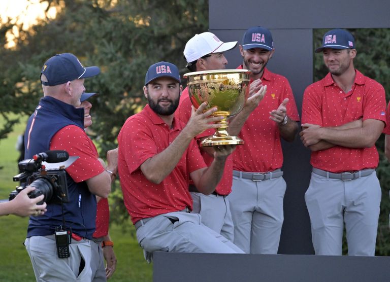 Sep 29, 2024; Ile Bizard, Quebec, CAN; Scottie Scheffler of Team USA celebrates with the trophy during the ceremony after the final round of The Presidents Cup golf tournament.