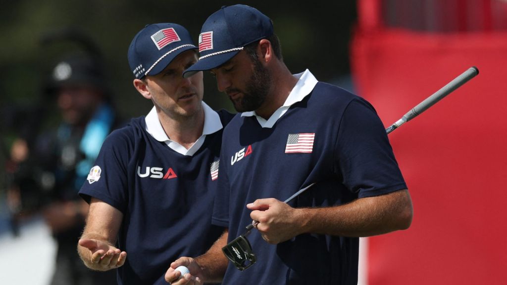 Golf - The 2025 Ryder Cup - Bethpage Black Golf Course, Farmingdale, New York, United States - September 27, 2025 Team USA's Russell Henley and Team USA's Scottie Scheffler react on the 18th green during the foursomes REUTERS/Paul Childs