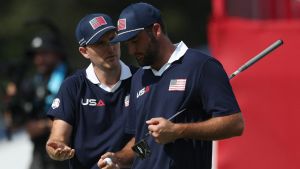Golf - The 2025 Ryder Cup - Bethpage Black Golf Course, Farmingdale, New York, United States - September 27, 2025 Team USA's Russell Henley and Team USA's Scottie Scheffler react on the 18th green during the foursomes REUTERS/Paul Childs