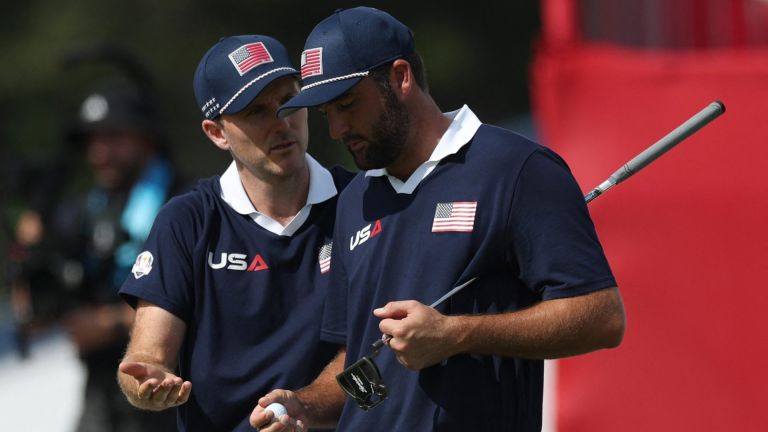 Golf - The 2025 Ryder Cup - Bethpage Black Golf Course, Farmingdale, New York, United States - September 27, 2025 Team USA's Russell Henley and Team USA's Scottie Scheffler react on the 18th green during the foursomes REUTERS/Paul Childs