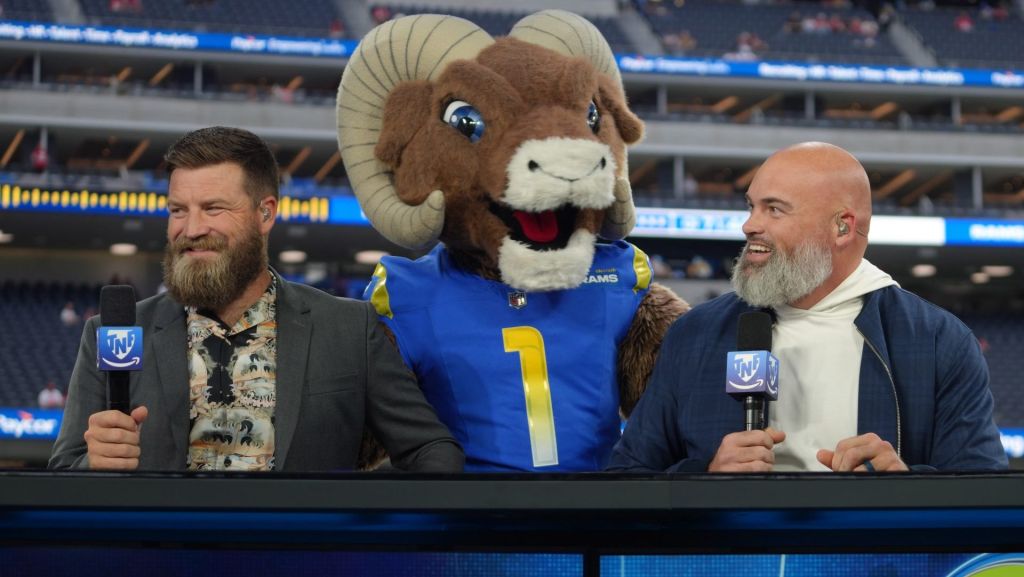 Oct 2, 2025; Inglewood, California, USA; Los Angeles Rams mascot Rampage (center) visits Ryan Fitzpatrick (left) and Andrew Whitworth on the Prime Thursday Night Football set at SoFi Stadium. Mandatory Credit: Kirby Lee-Imagn Images