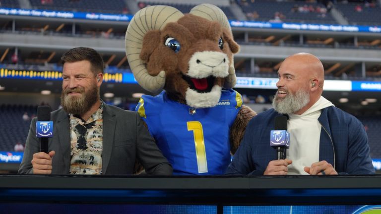 Oct 2, 2025; Inglewood, California, USA; Los Angeles Rams mascot Rampage (center) visits Ryan Fitzpatrick (left) and Andrew Whitworth on the Prime Thursday Night Football set at SoFi Stadium. Mandatory Credit: Kirby Lee-Imagn Images