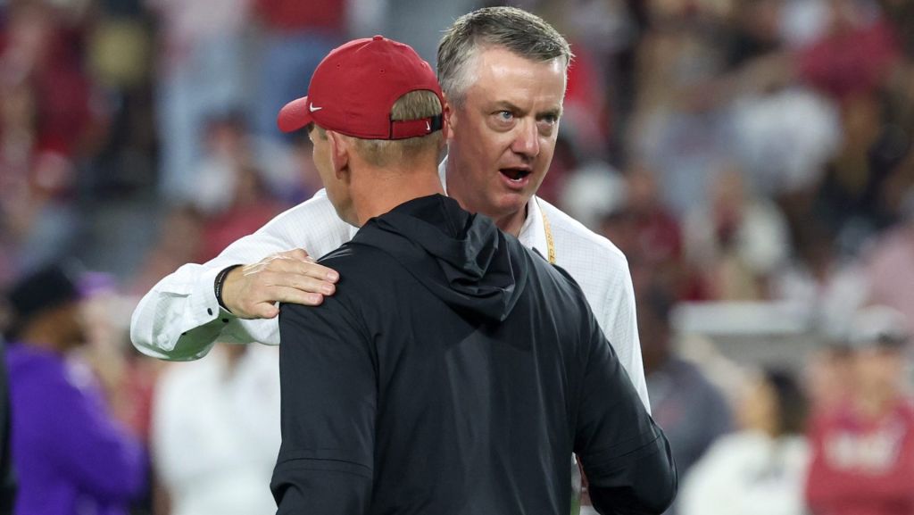 Nov 8, 2025; Tuscaloosa, Alabama, USA; Alabama Crimson Tide head coach Kalen Deboer speaks to athletic director Greg Byrne prior to the game against the Louisiana State Tigers at Saban Field at Bryant-Denny Stadium. Mandatory Credit: David Leong-Imagn Images