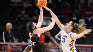 Louisiana State Tigers guard Flau'jae Johnson (4) and Louisiana State Tigers forward Kate Koval (13) defend the shot of Oklahoma Sooners center Raegan Beers (15) Friday, March 6, 2026, during the SEC Women's Basketball Tournament quarterfinals game at Bon Secours Wellness Arena in Greenville, South Carolina.