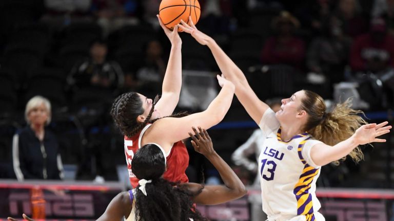Louisiana State Tigers guard Flau'jae Johnson (4) and Louisiana State Tigers forward Kate Koval (13) defend the shot of Oklahoma Sooners center Raegan Beers (15) Friday, March 6, 2026, during the SEC Women's Basketball Tournament quarterfinals game at Bon Secours Wellness Arena in Greenville, South Carolina.