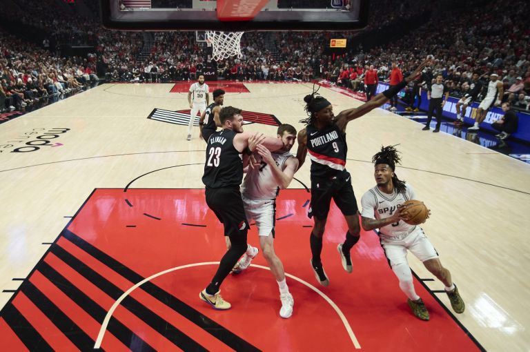 Apr 26, 2026; Portland, Oregon, USA; San Antonio Spurs guard Stephon Castle (5) drives to the basket during the first half against Portland Trail Blazers forward Jerami Grant (9) during game four of the first round of the 2026 NBA Playoffs at Moda Center.