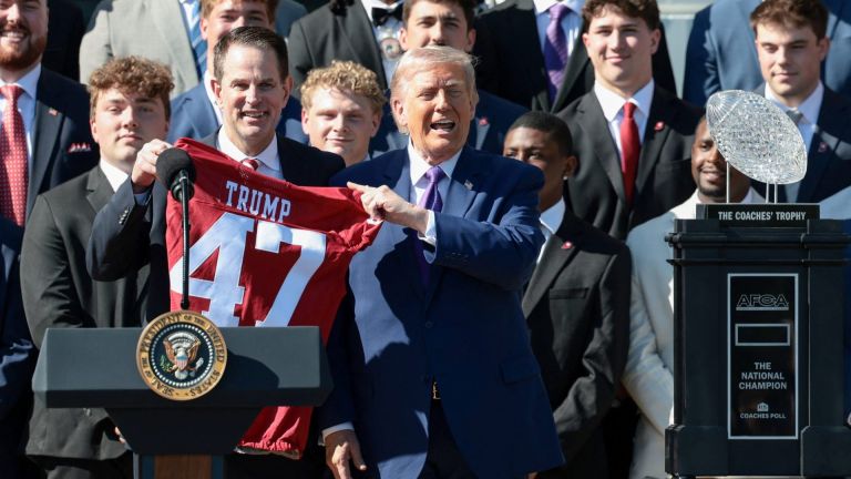 U.S. President Donald Trump receives a jersey from head football coach at Indiana University, Curt Cignetti, as the president hosts the 2026 College Football Playoff (CFP) National Champions from Indiana University at the White House in Washington, D.C., U.S., May 11, 2026. REUTERS/Evelyn Hockstein