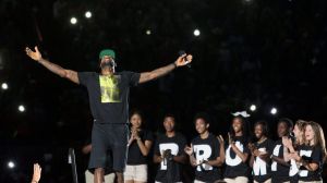 LeBron James acknowledges the crowd's reaction as he takes the stage for the I PROMISE Family Reunion event to welcome him home on Friday at InfoCision Stadium in Akron. The event was hosted by the LeBron James Family Foundation.