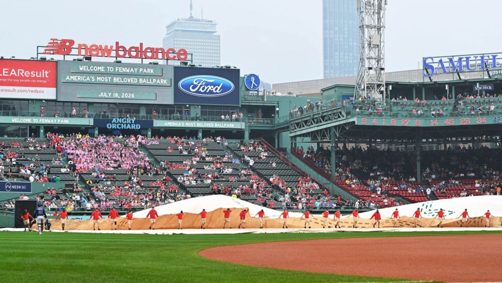 Jul 18, 2026; Boston, Massachusetts, USA; The Boston Red Sox ground crew remove the field tarp after a rain delay before a game against the Tampa Bay Rays at Fenway Park. Mandatory Credit: Eric Canha-Imagn Images