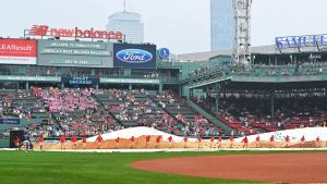 Jul 18, 2026; Boston, Massachusetts, USA; The Boston Red Sox ground crew remove the field tarp after a rain delay before a game against the Tampa Bay Rays at Fenway Park. Mandatory Credit: Eric Canha-Imagn Images