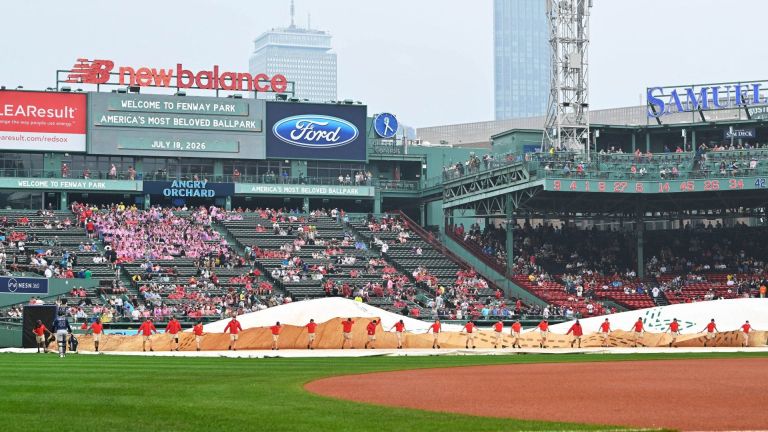 Jul 18, 2026; Boston, Massachusetts, USA; The Boston Red Sox ground crew remove the field tarp after a rain delay before a game against the Tampa Bay Rays at Fenway Park. Mandatory Credit: Eric Canha-Imagn Images