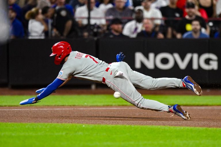Sep 17, 2026; New York City, New York, USA; Philadelphia Phillies shortstop Trea Turner (7) dives safely into third base after advancing on an errant New York Mets pickoff throw to first base during the seventh inning at Citi Field. novig