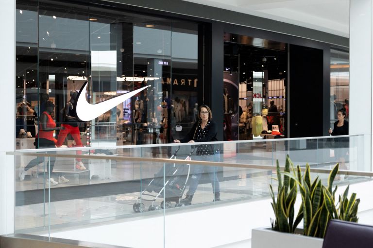 A shopper walks past a Nike store, as global markets brace for a hit to trade and growth caused by U.S. President Donald Trump's decision to impose import tariffs on dozens of countries, in the King of Prussia Mall in King of Prussia, Pennsylvania, U.S., April 3, 2025.