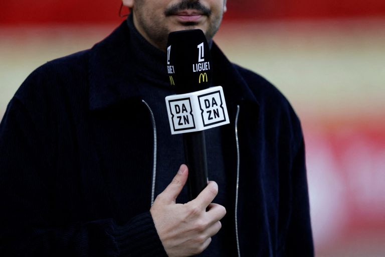 Soccer Football - Ligue 1 - AS Monaco v RC Strasbourg - Stade Louis II, Monaco, - April 19, 2025 TV pundit holds a DAZN microphone before the match