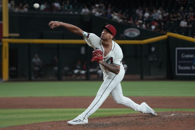 Jun 9, 2025; Phoenix, Arizona, USA; Arizona Diamondbacks pitcher Justin Martinez (63) throws against the Seattle Mariners in the ninth inning at Chase Field.