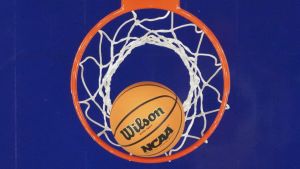 Apr 3, 2026; Phoenix, AZ, USA; Detail view of an NCAA basketball in the hoop during the second half of a semifinal of the Final Four of the women's 2026 NCAA Tournament between the UConn Huskies and the South Carolina Gamecocks at Mortgage Matchup Center. Mandatory Credit: Kirby Lee-Imagn Images