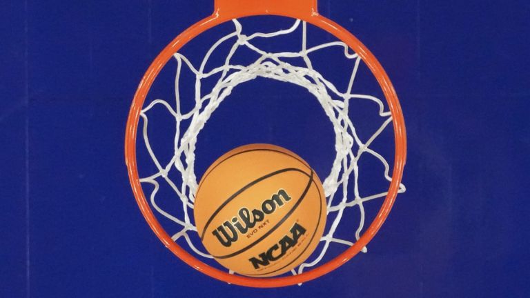 Apr 3, 2026; Phoenix, AZ, USA; Detail view of an NCAA basketball in the hoop during the second half of a semifinal of the Final Four of the women's 2026 NCAA Tournament between the UConn Huskies and the South Carolina Gamecocks at Mortgage Matchup Center. Mandatory Credit: Kirby Lee-Imagn Images