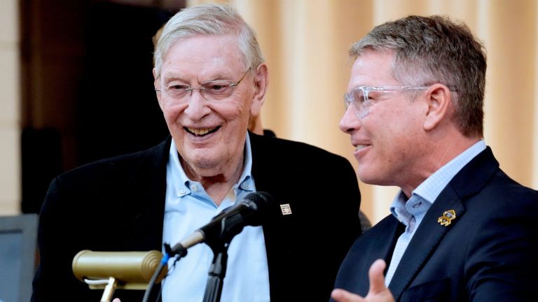 Former Major League Baseball Commissioner, Bud Selig, left, is introduced by Brewers broadcaster Brian Anderson at the Clinton Rose Senior Center on July 20, 2026, at a program to celebrate and honor the 755th home run of Hank Aaron from 1976. The event featured the viewing of a textile mural created by local artist, Rosy Petri.