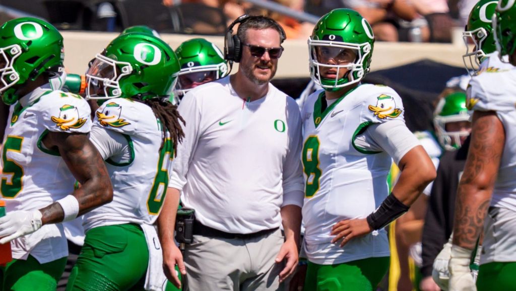 Oregon head coach Dan Lanning talks to Oregon quarterback Dylan Raiola on the sideline as the Oregon Ducks face the Oklahoma State Cowboys on Sept. 12, 2026, at Boone Pickens Stadium in Stillwater, Oklahoma.