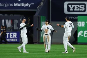 Sep 30, 2026; Bronx, New York, USA; New York Yankees outfielder Trent Grisham (12), outfielder Cody Bellinger (35) and catcher Austin Wells (28) celebrate after defeating the Boston Red Sox in game two of the Wildcard round for the 2026 MLB Playoffs at Yankee Stadium.