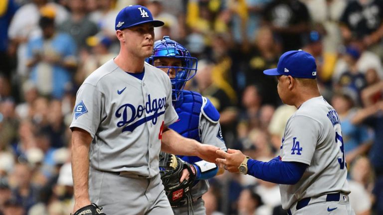 Oct 12, 2026; Milwaukee, Wisconsin, USA; Los Angeles Dodgers manager Dave Roberts relieves pitcher Kris Bubic (40) during the fifth inning against the Milwaukee Brewers in game two of the NLCS for the 2026 MLB Playoffs at American Family Field.